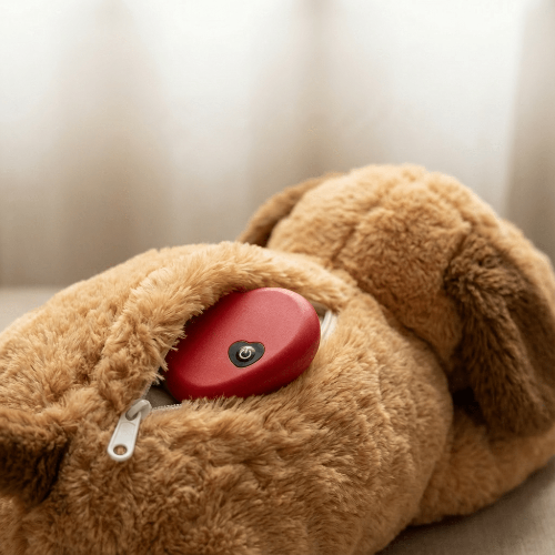 Brown plush dog toy with a red heart inside on a neutral background